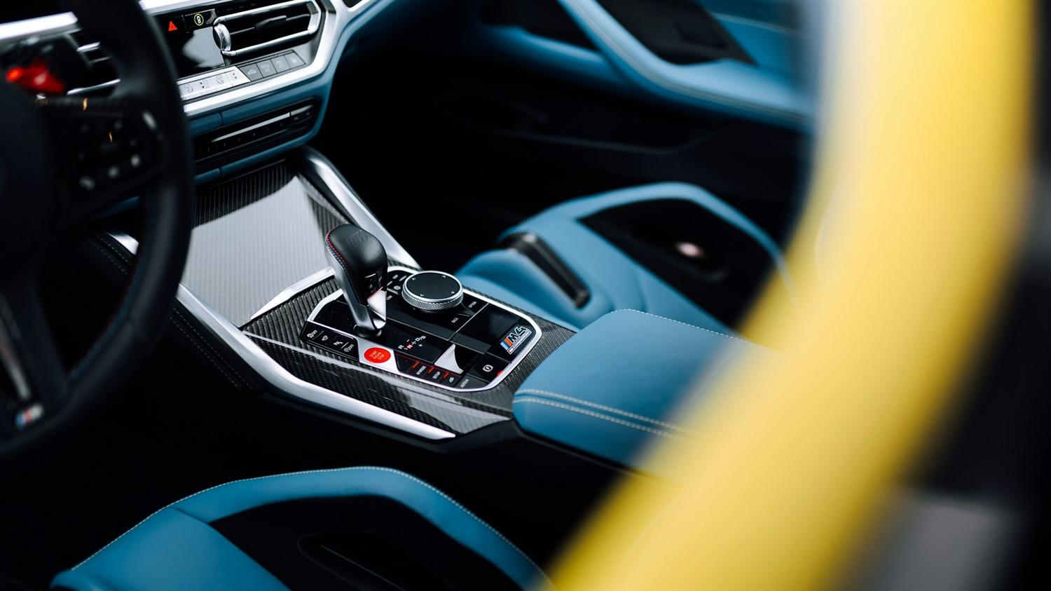 Sports car cabin with carbon trim and blue leather seats