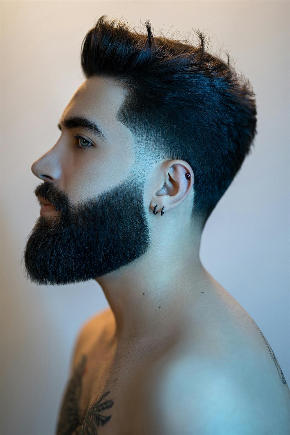 Profile of a man with a skin fade and a sculpted full beard